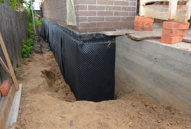 SJ Waterproofing Pros technician performing targeted Wet Basement Repair assessment in Burnsville, MN